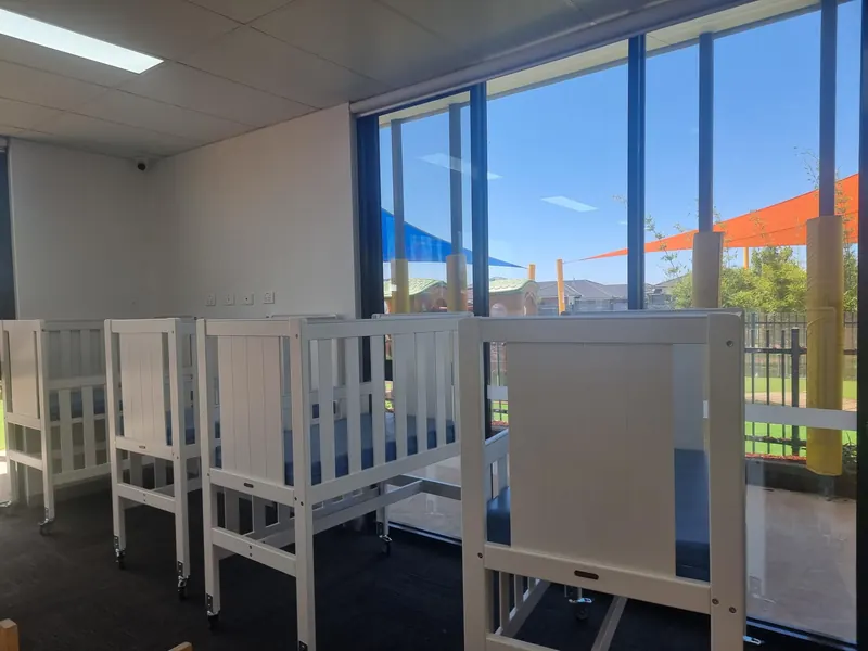 Cot room in the babies and nursery area with white timber cots