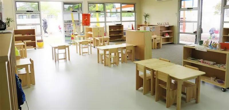 Buffalo Campus classroom with child-sized tables and Montessori shelves