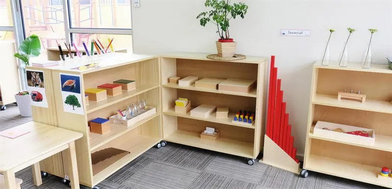 Buffalo Campus shelves with the Montessori pink tower and red rods