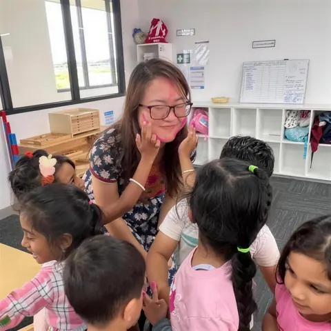 Educator sharing a moment with a group of children in the classroom