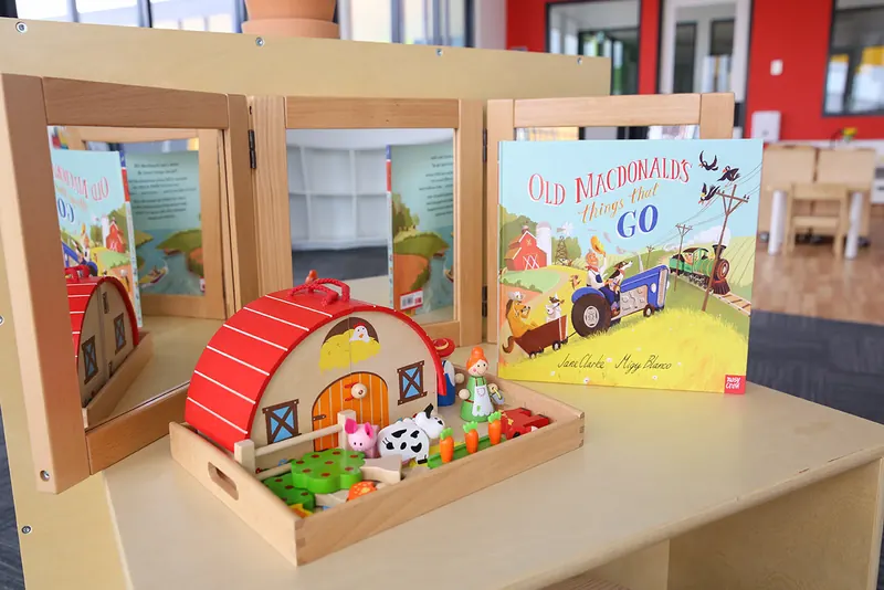 Story basket with a farm play set and picture book for early language
