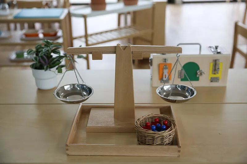 Wooden balance scales with counting beads, a hands-on Montessori maths material