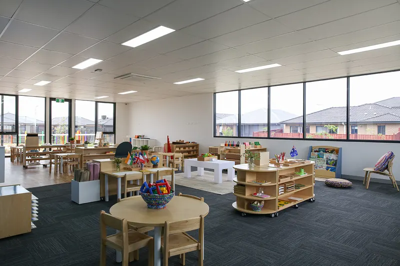 Montessori classroom filled with natural light from floor-to-ceiling windows