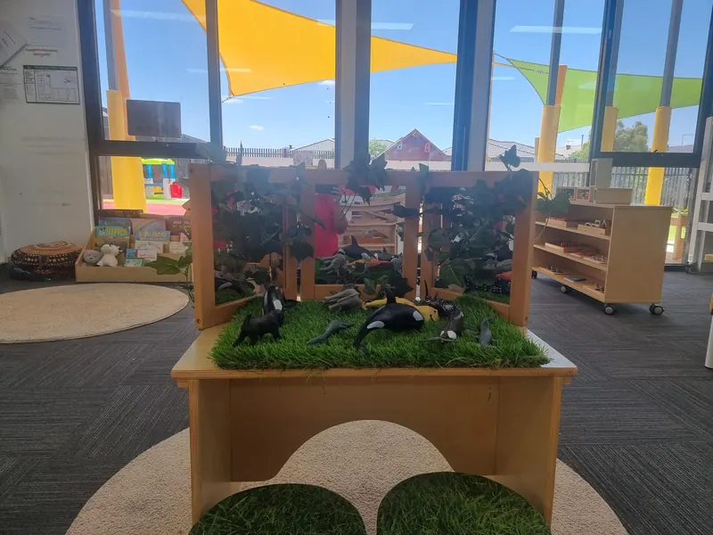 Nature discovery table with Australian bird figures in the nursery room
